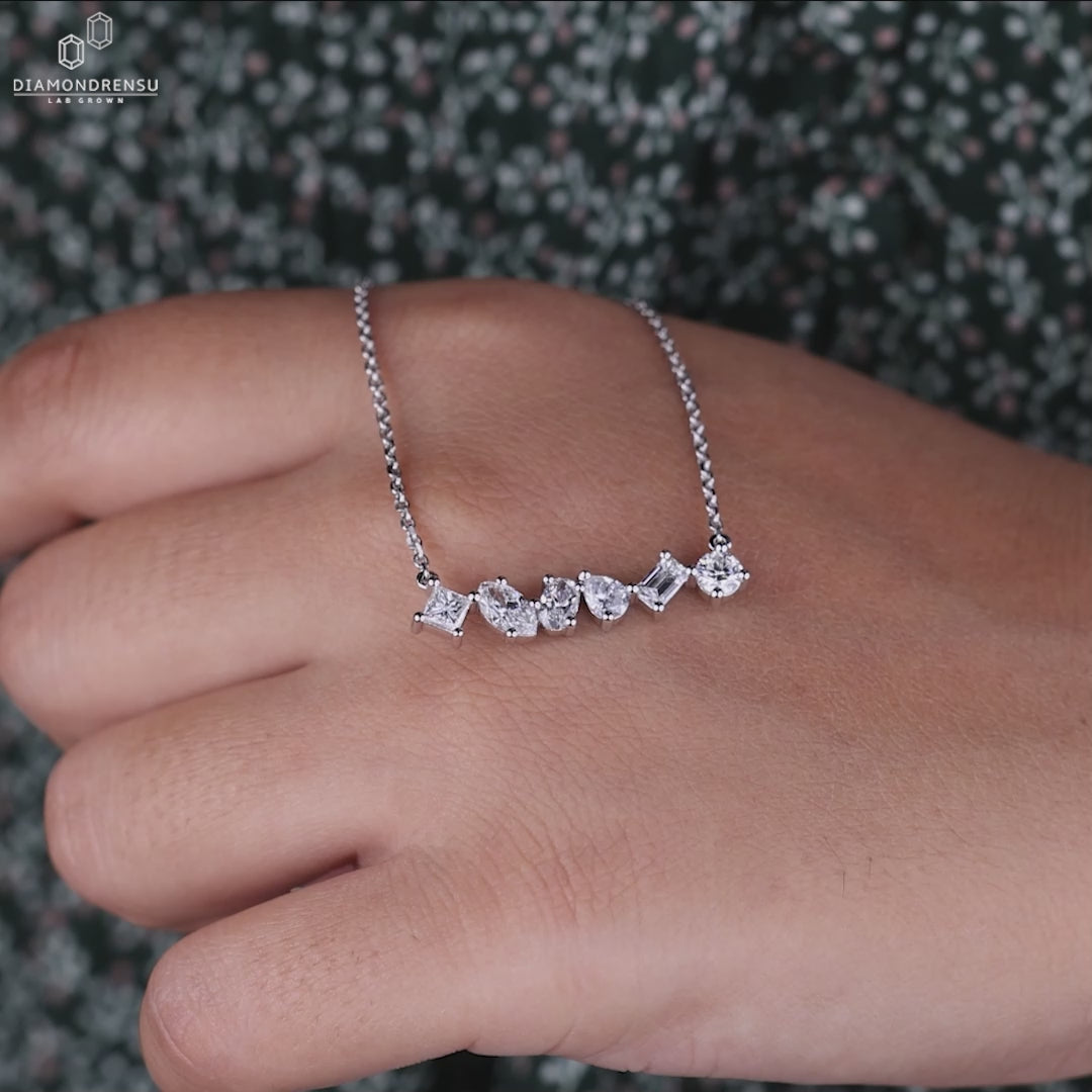 Princess cut diamond paired with marquise and pear shapes in a custom pendant.