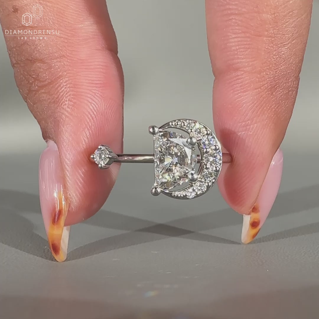 White gold engagement ring with round and half moon diamonds
