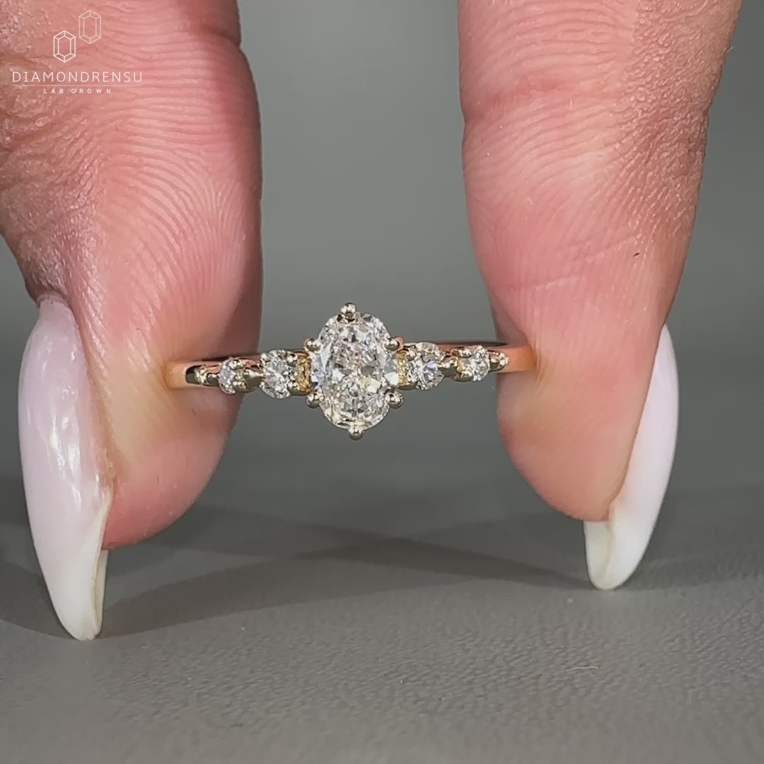 Oval cut diamond ring with round side stones