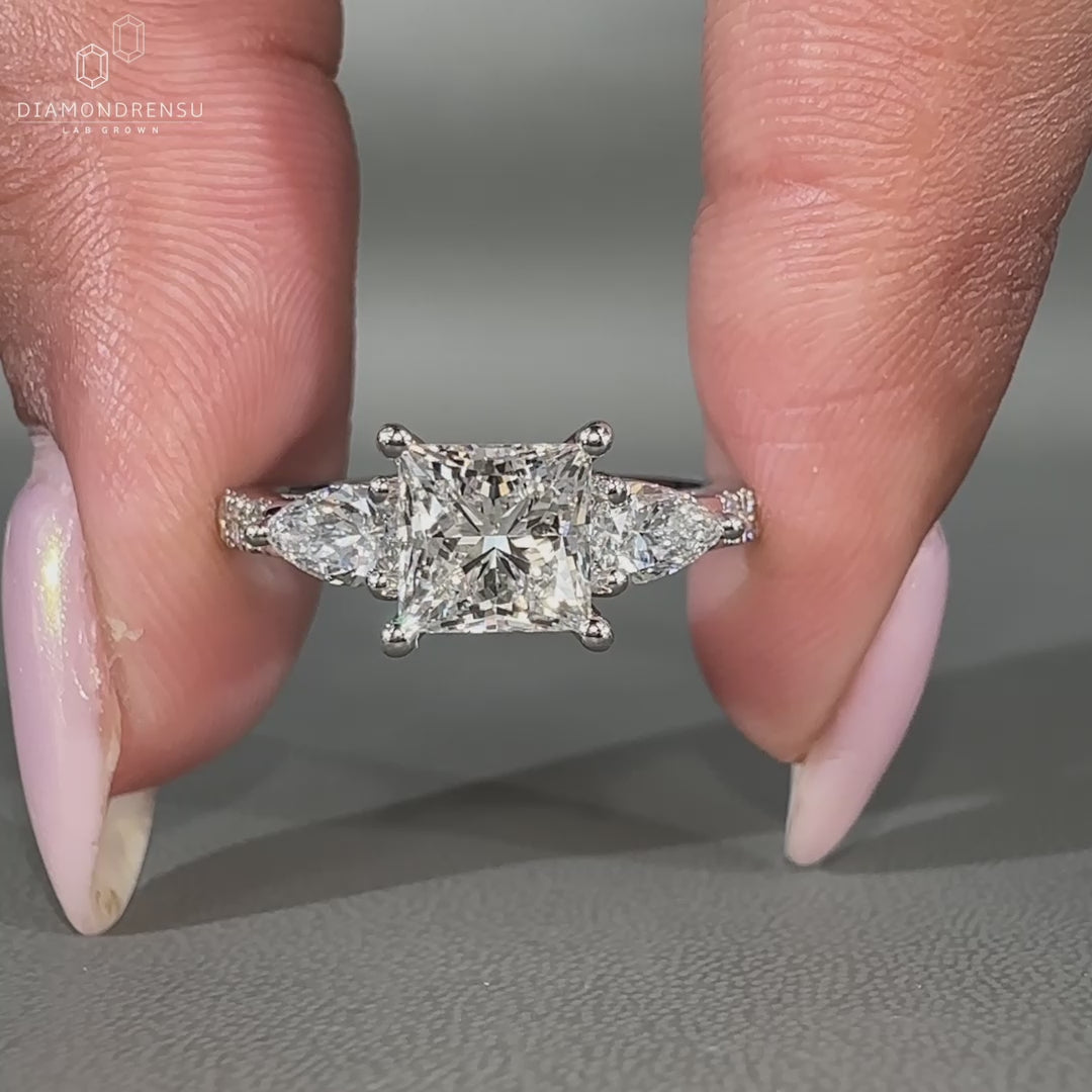 White gold ring with round pave band and pear side stones