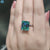 Diamondrensu UK ring showcasing a solitaire criss cut moissanite.