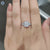 Handmade moissanite ring with cushion and round cuts in prong setting.