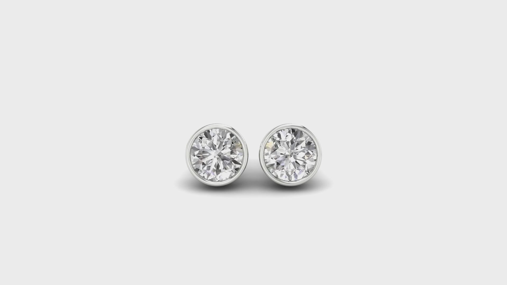 Lab grown diamond bezel earrings in classic round cut, white gold finish.