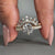 Compass prong setting ring paired with prong set wedding band in yellow gold.