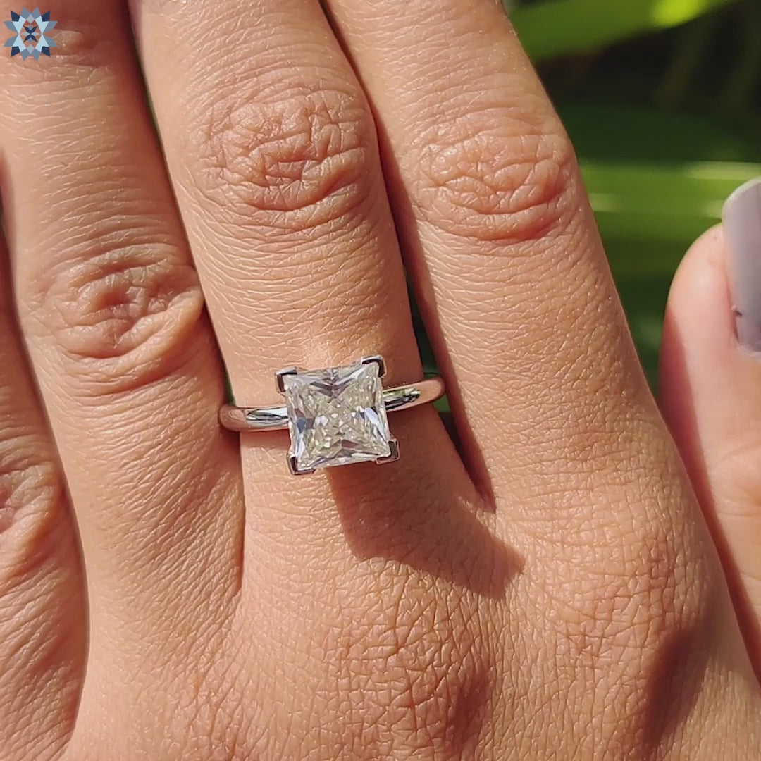 V prong setting ring with princess cut center stone.