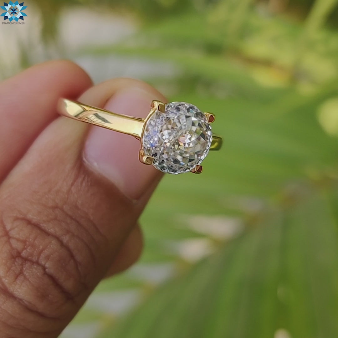 Moissanite ring in 4 prong yellow gold setting.