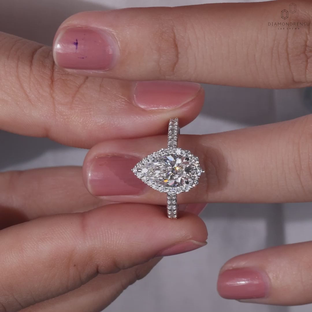 Classic halo diamond engagement ring with elegant claw prongs.