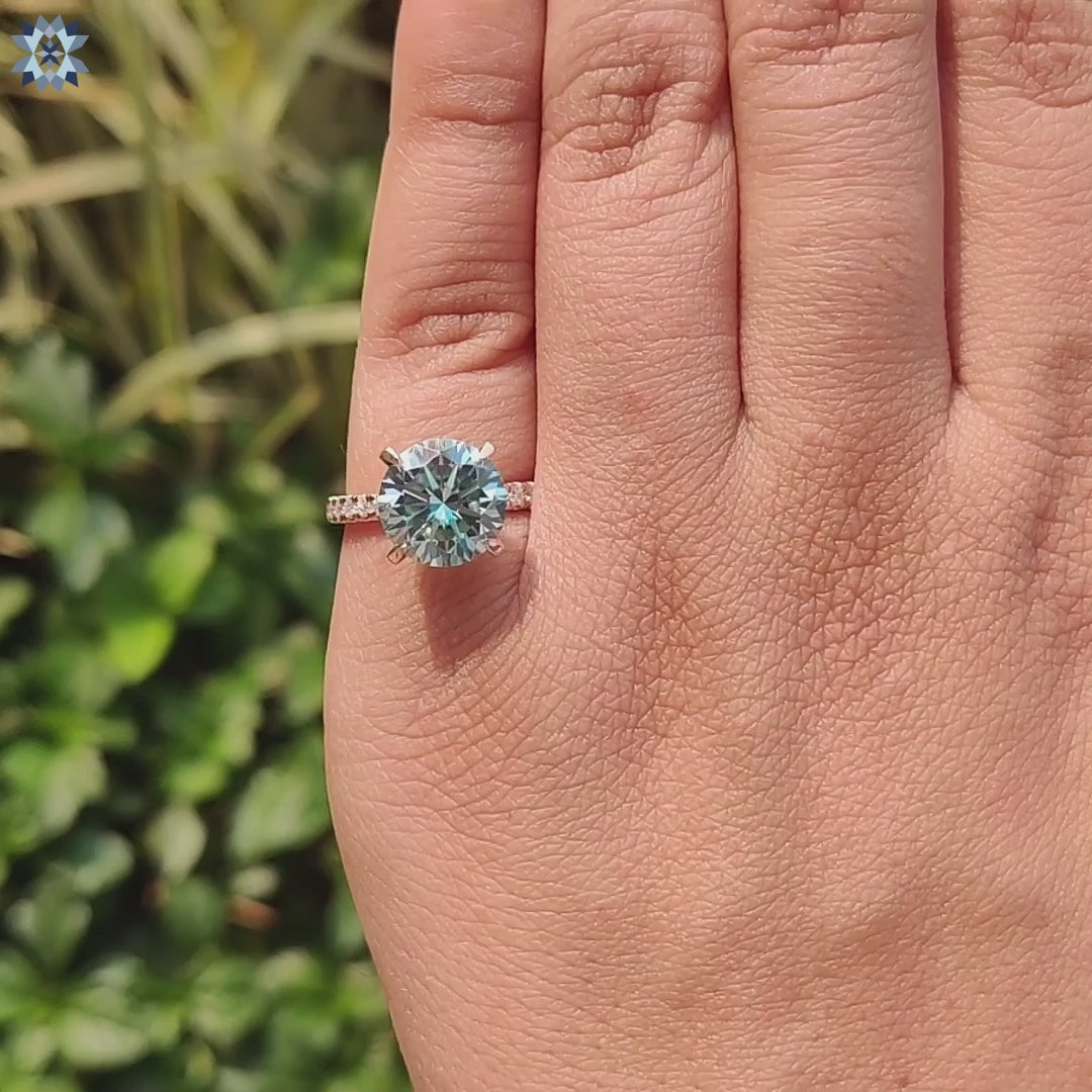 Moissanite pave ring with hidden halo in rose gold setting.