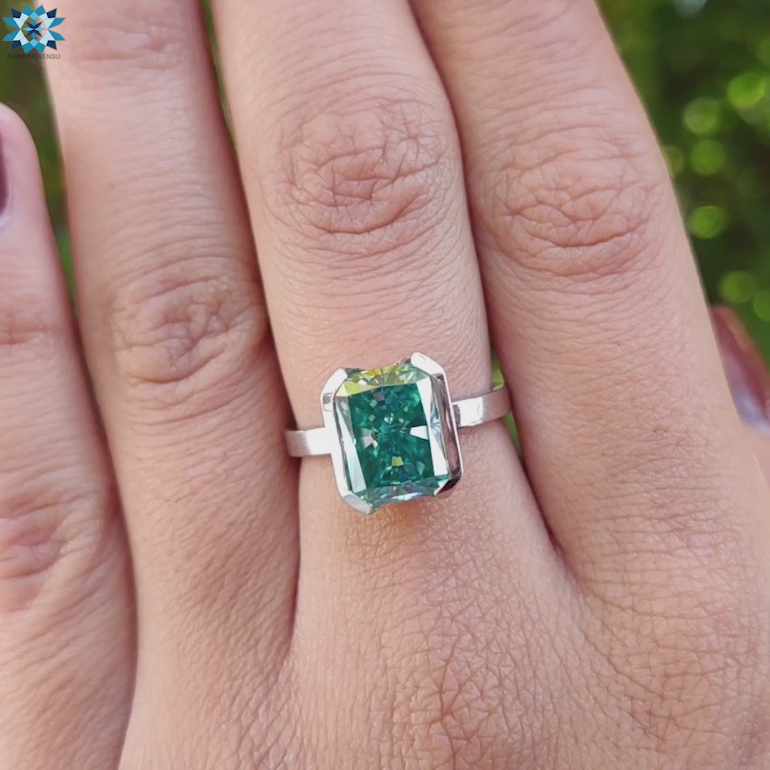 Radiant cut solitaire moissanite ring in white gold band.