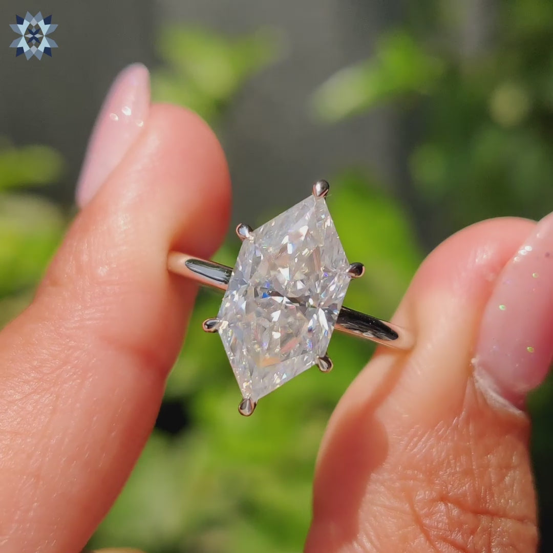 Hidden halo engagement ring featuring Dutch marquise cut Moissanite and round cut accents.