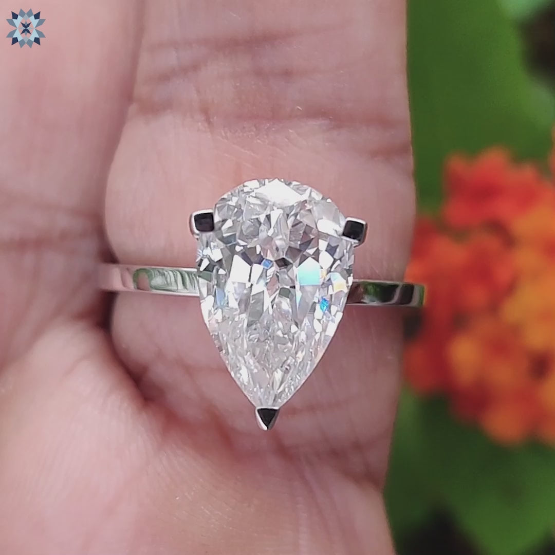 Buy pear solitaire moissanite ring in white gold.