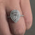 Halo ring crafted with a pear shaped diamond and set as a uk engagement ring.