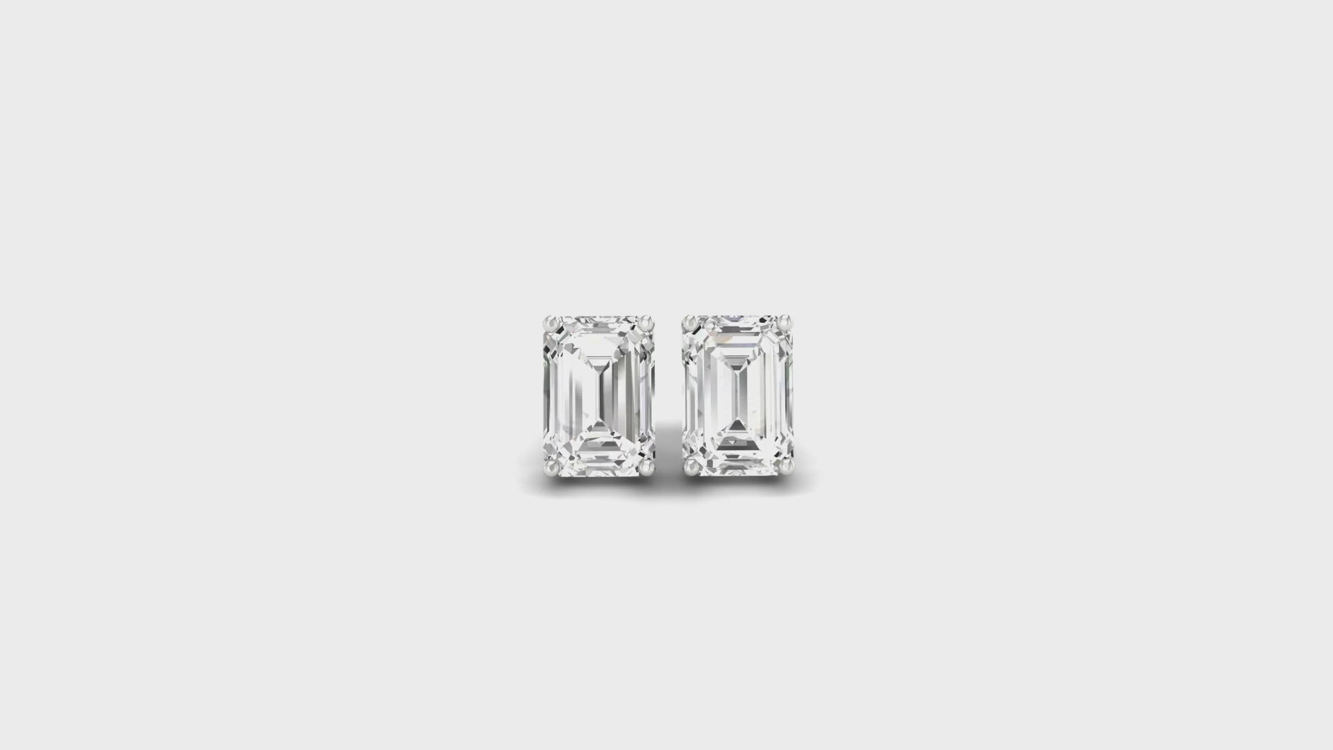 Emerald cut diamond stud earrings in white gold with secure screw back design.