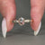 Three stone engagement ring with oval and round diamonds