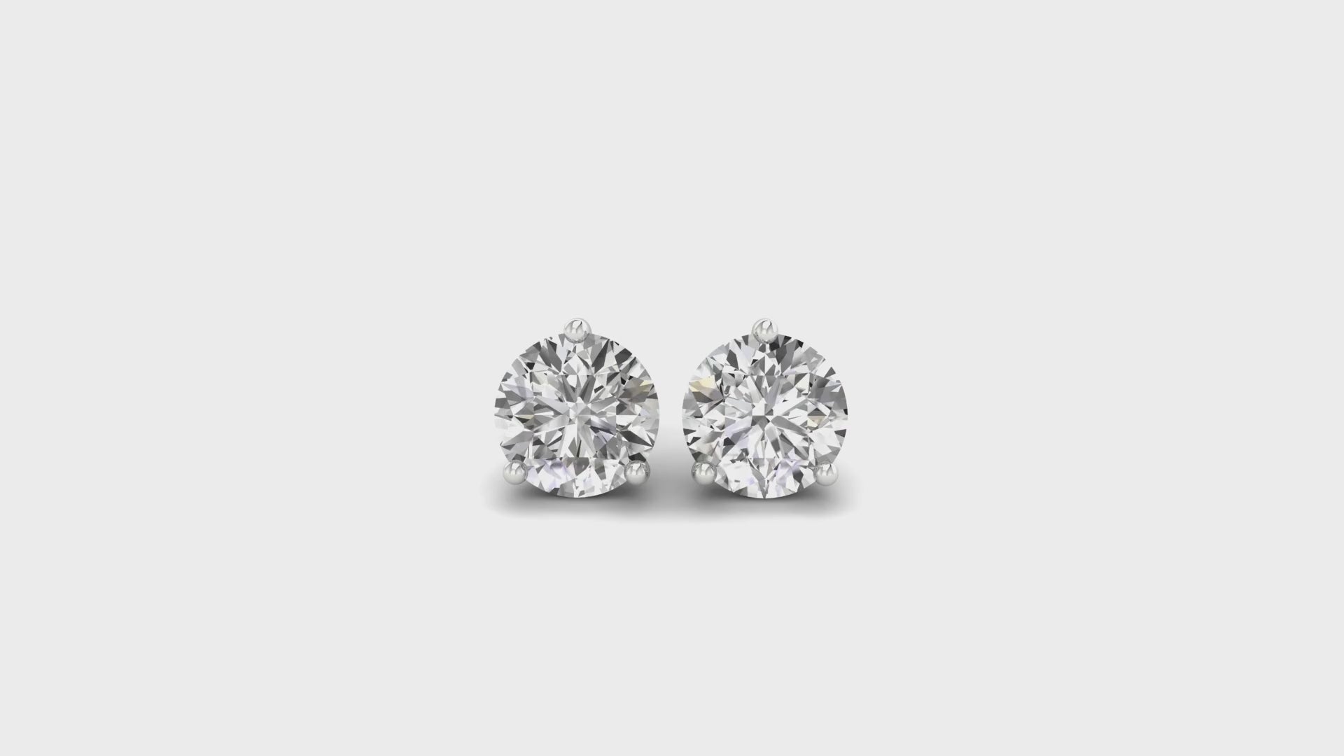 Round cut diamond stud earrings in white gold with screw back design.