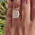 Handmade jewelry ring with matte finish and moissanite center.