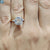 Diamondrensu UK ring with three moissanite stones in yellow gold.