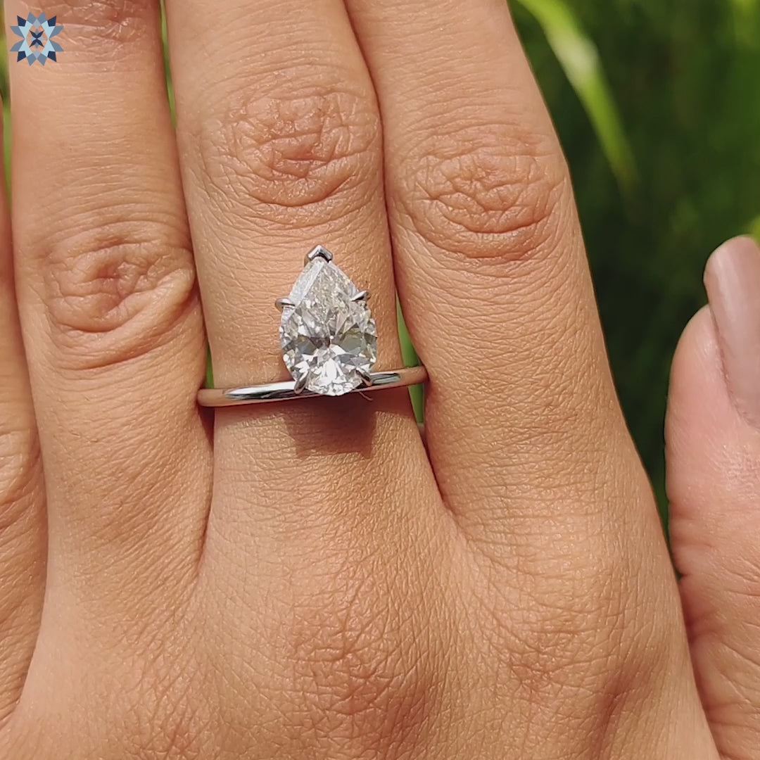 Custom engagement ring in prong setting with upside down pear cut centre stone.
