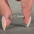 Round cut diamond band featuring lab grown stones in a half eternity style.