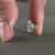 Diamond ring UK featuring a pear cut diamond with round side stones, crafted for a modern and elegant design.