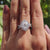 Double claw prong ring with oval cut moissanite center.