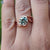 Rose gold solitaire ring with tension set moissanite.