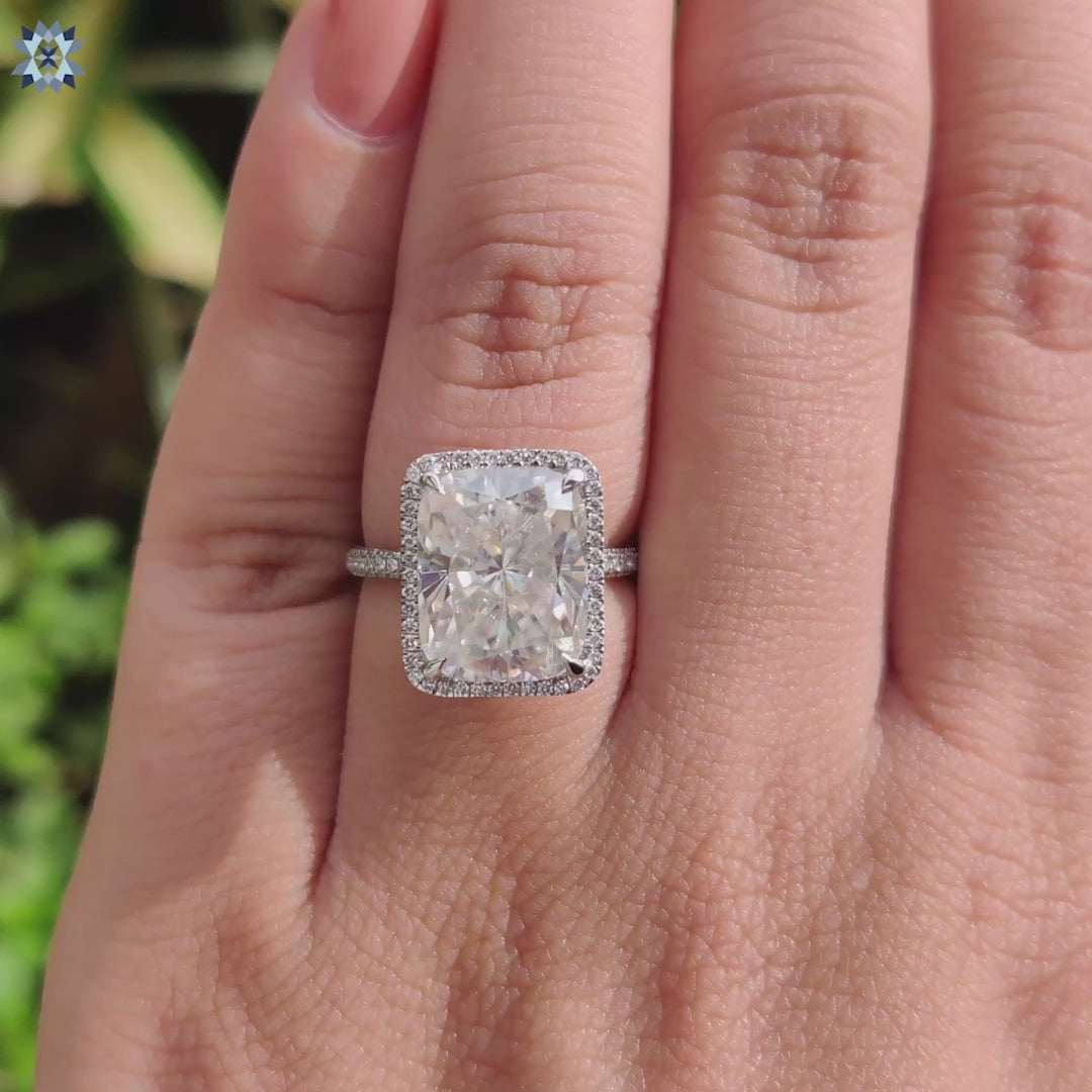 Handmade moissanite ring with round cut accent stones.