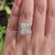 Handmade moissanite ring with round cut accent stones.