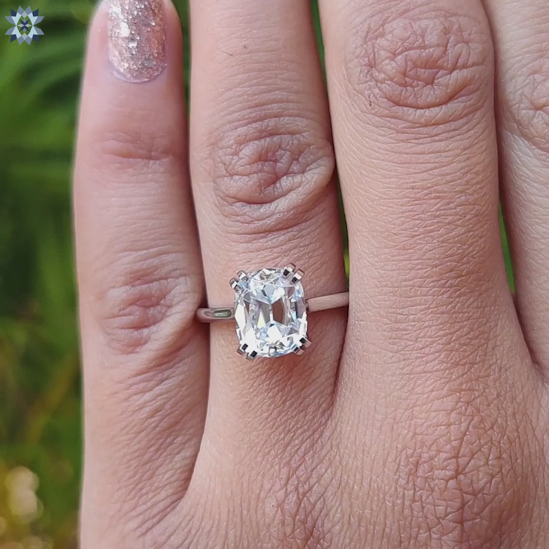 Prong setting cushion cut moissanite ring in white gold.