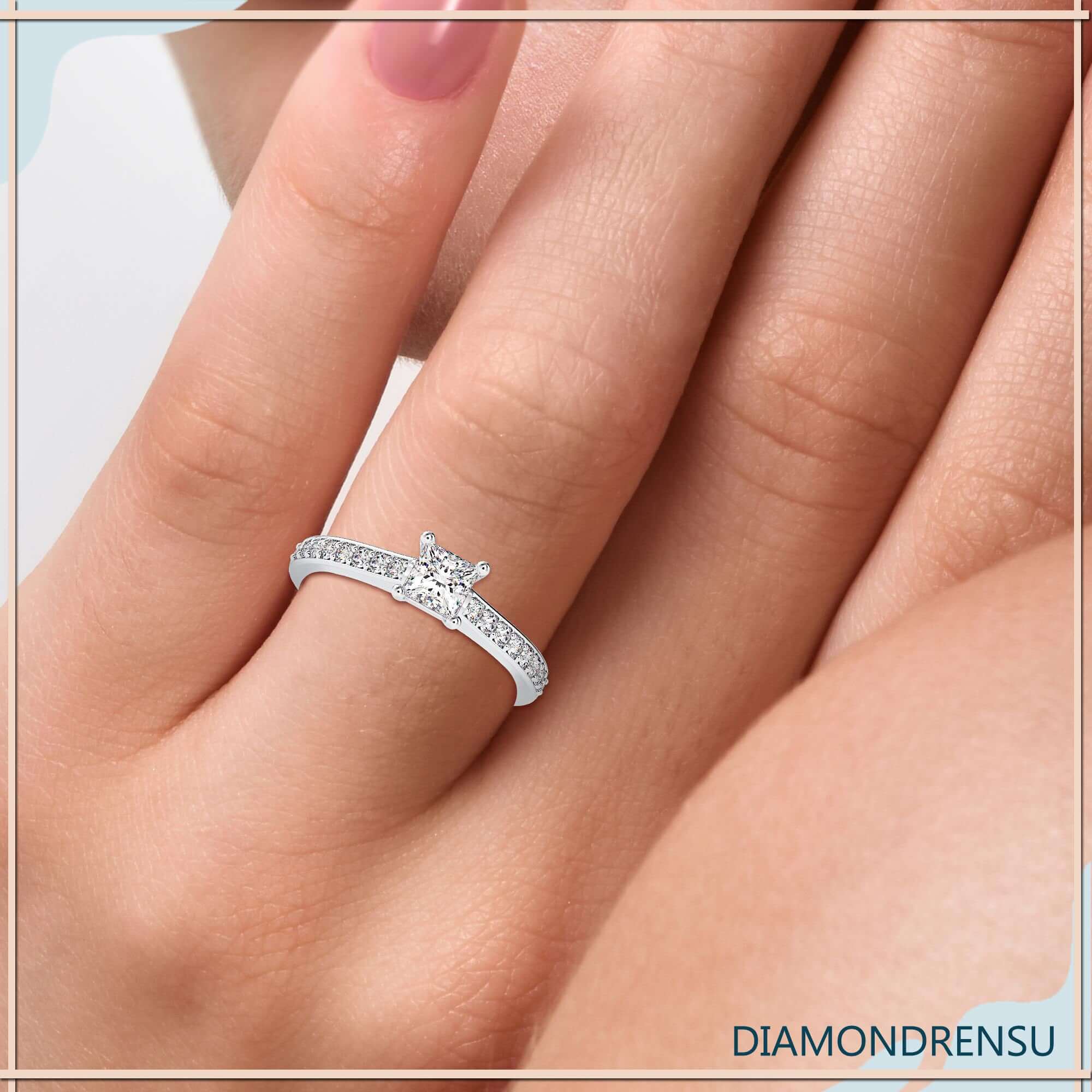 Princess cut engagement ring in yellow gold finish.