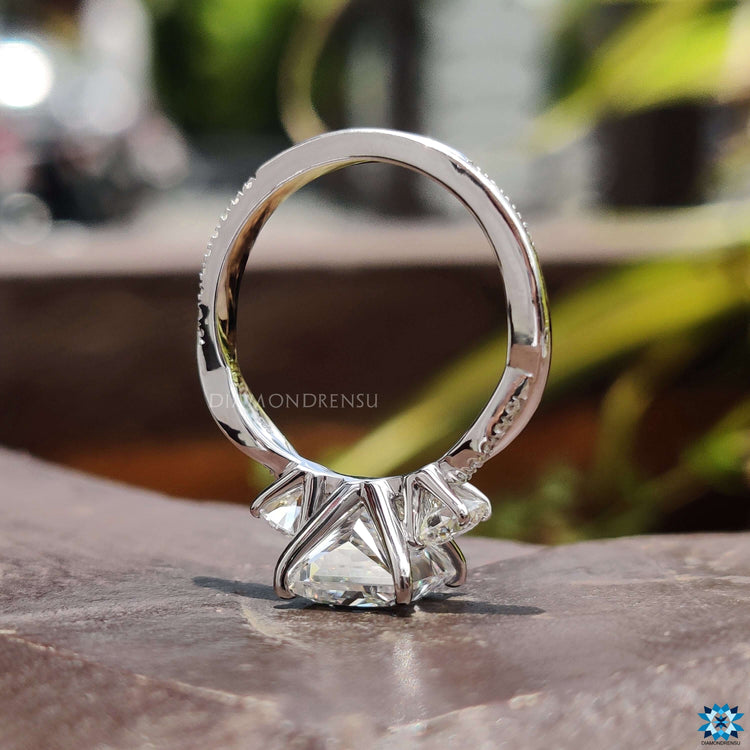 Three stone engagement ring with round side stones.