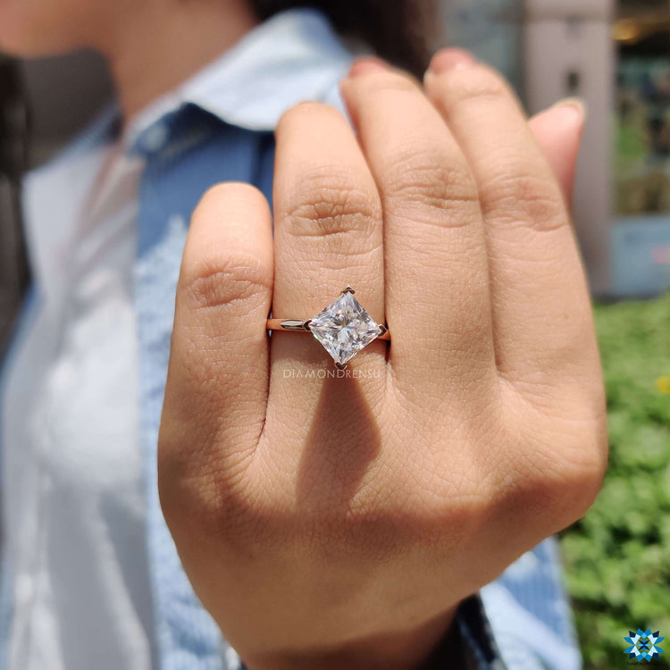 Princess cut ring with compass prong setting.
