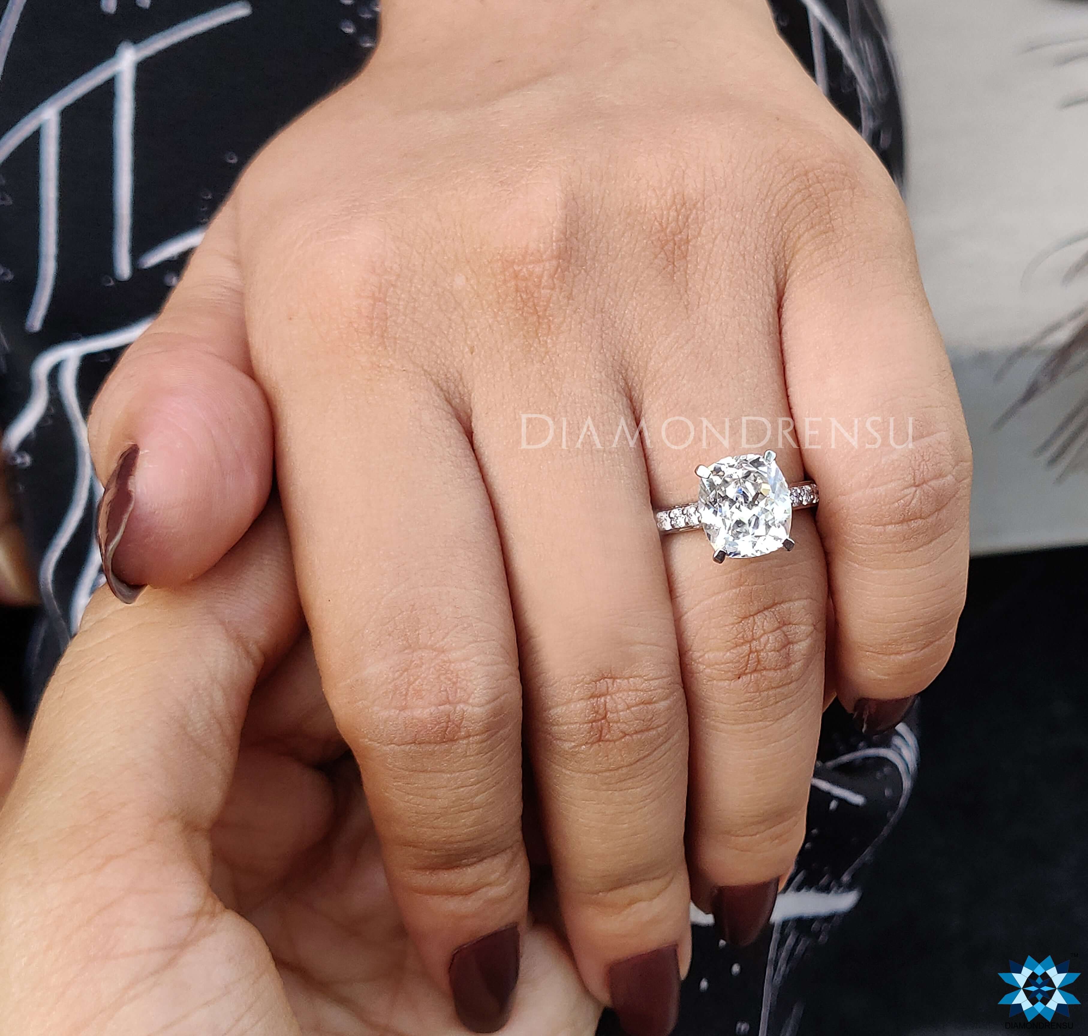 Cathedral ring with a cushion cut engagement ring for extra shine.