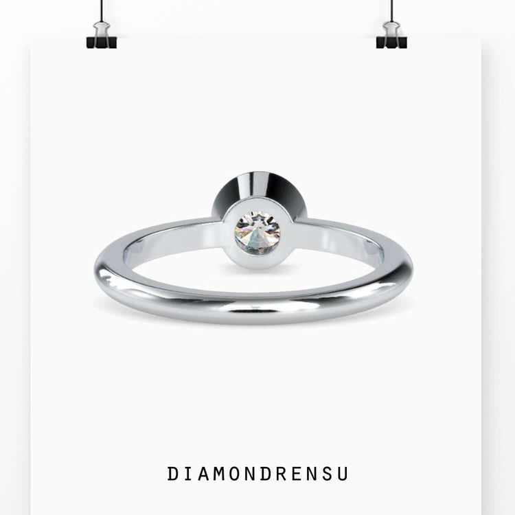 Custom design ring with bezel set round lab grown diamond.