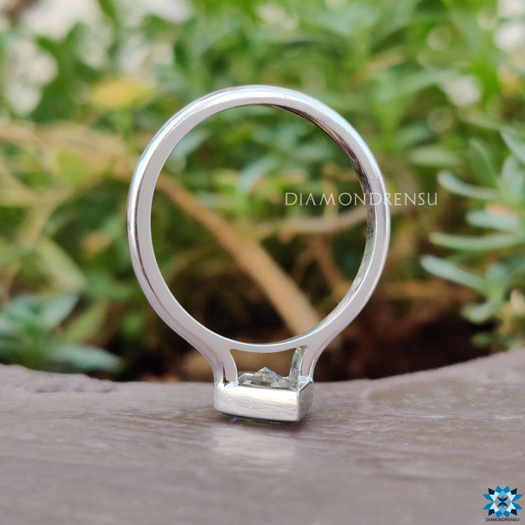 Moissanite ring featuring lozenge center in white gold.