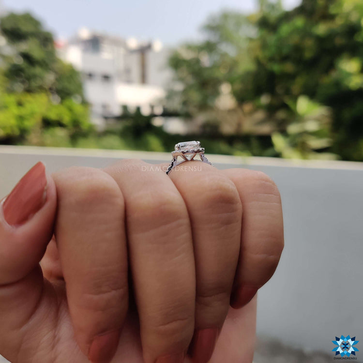 White gold ring with cushion Rensu center and round pave details.