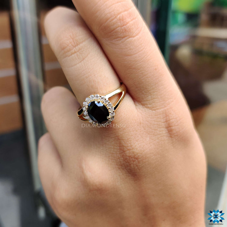 Yellow gold halo engagement ring with black moissanite.