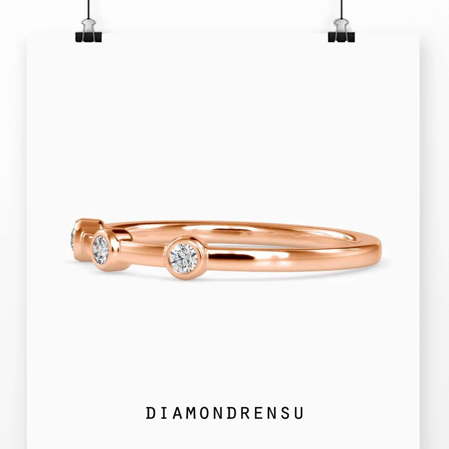 Bezel wedding band with three stone diamond layout.