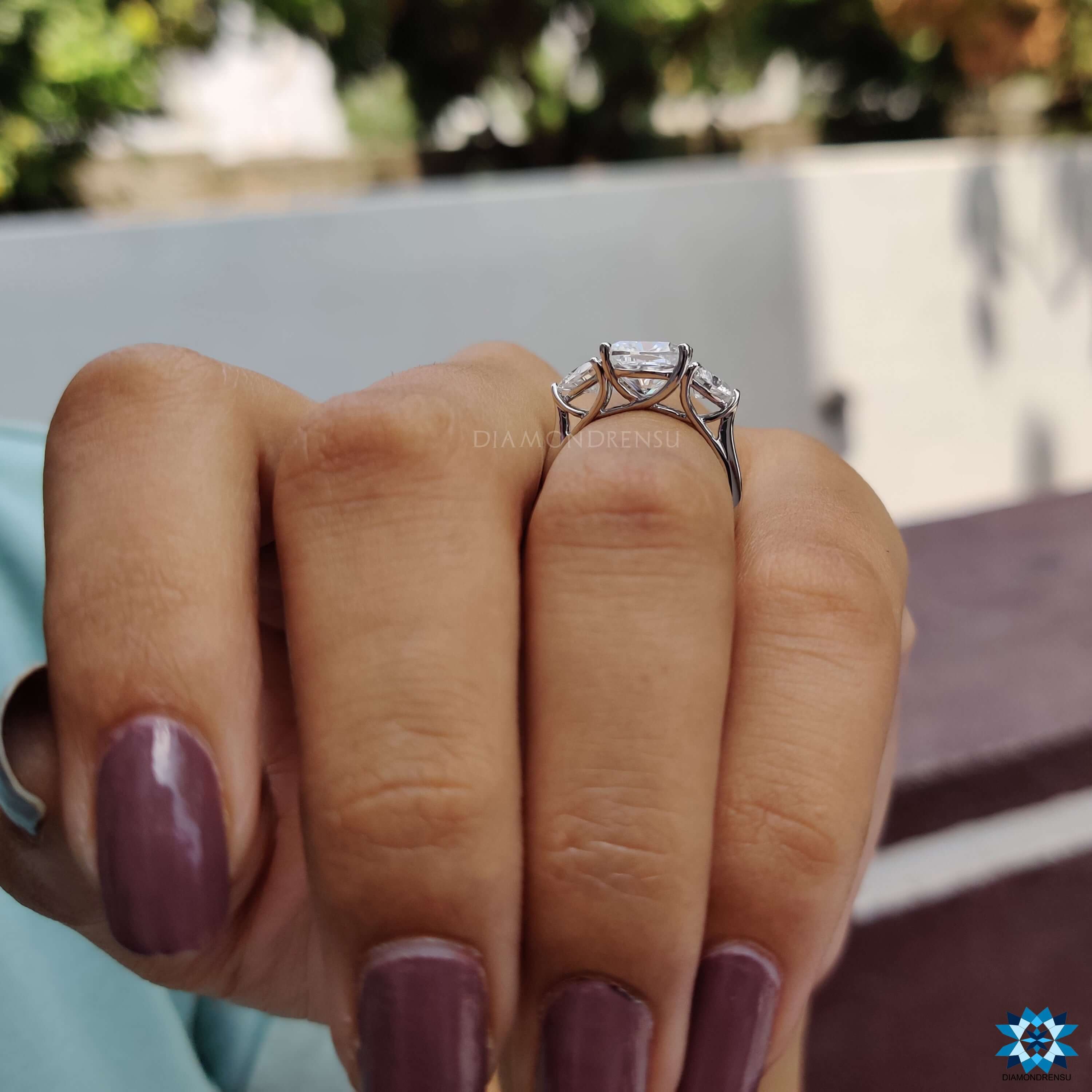 Diamondrensu UK moissanite ring with cushion and side accents.