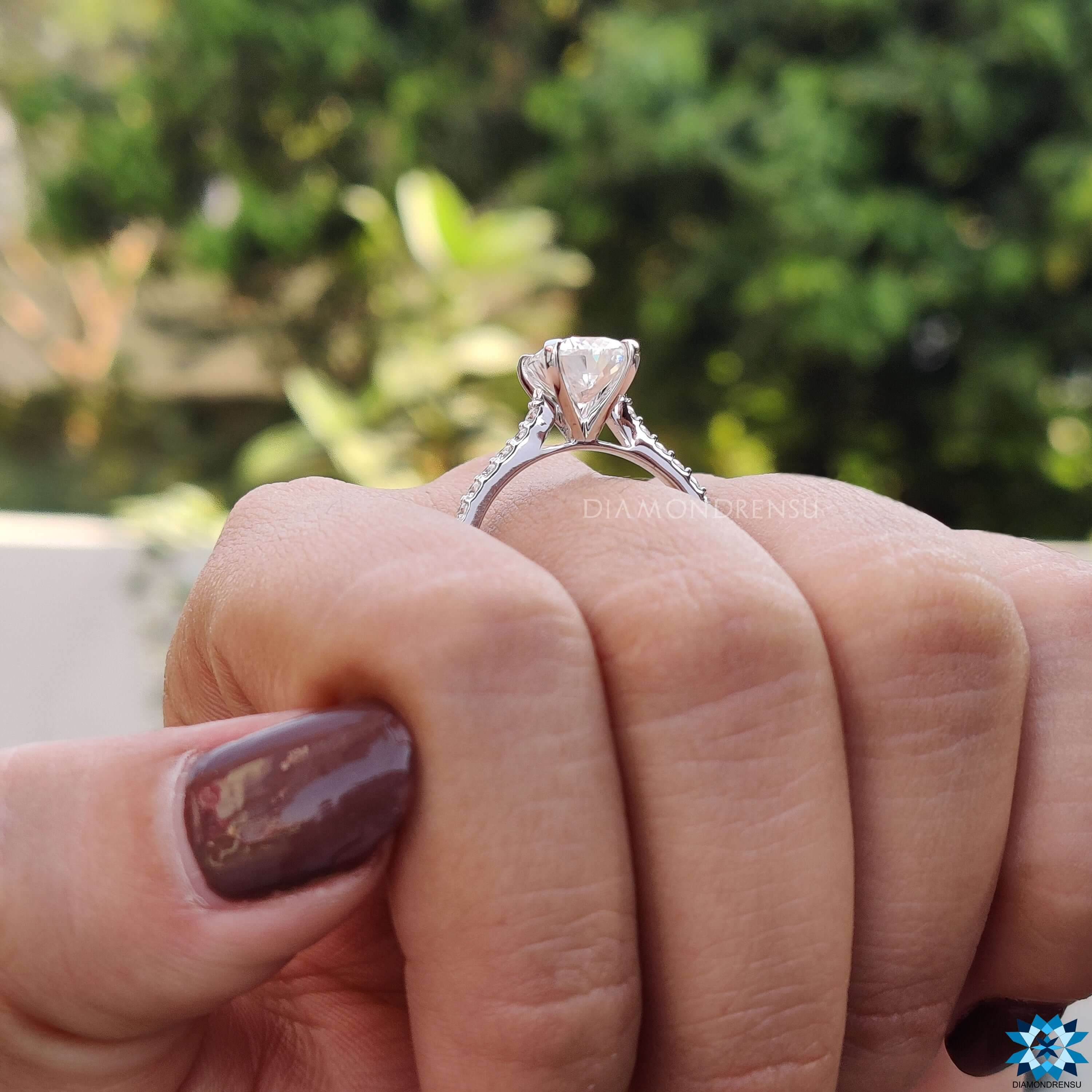 Cushion center engagement ring with moissanite and handcrafted details.