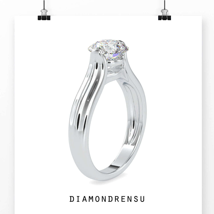 Designer ring with round diamond in solitaire tension set.
