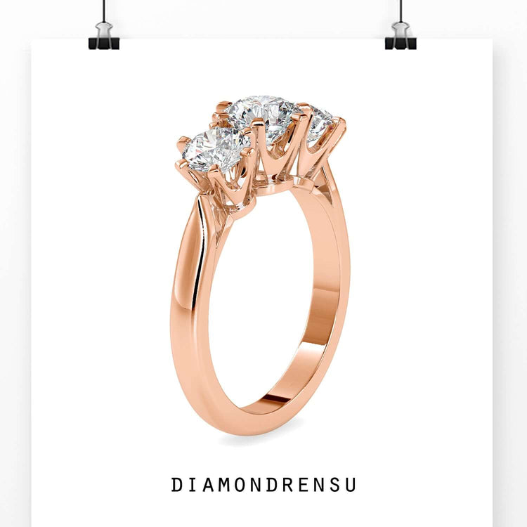 Lab grown diamond ring with three round stones in rose gold.