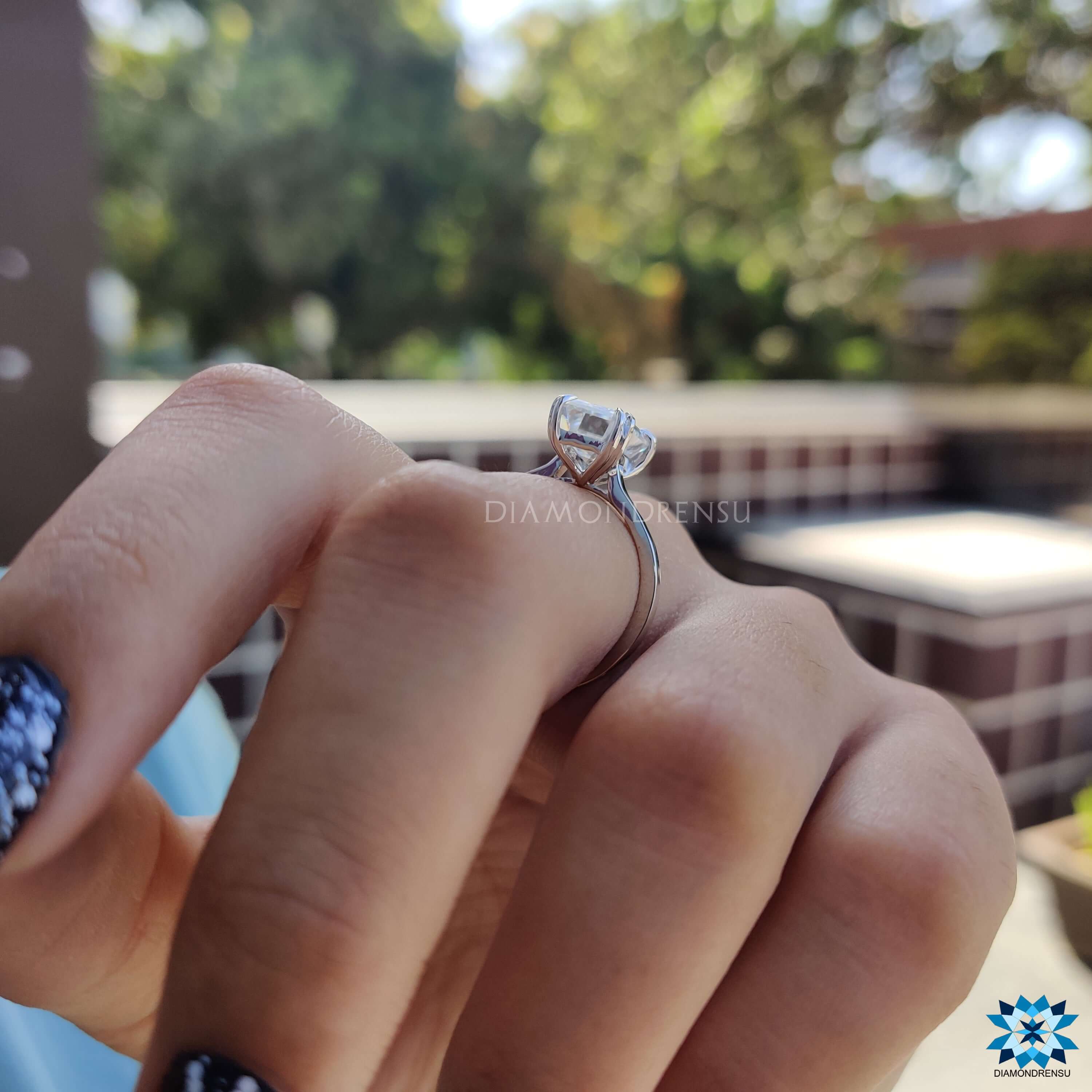 Handmade emerald cut moissanite engagement ring.