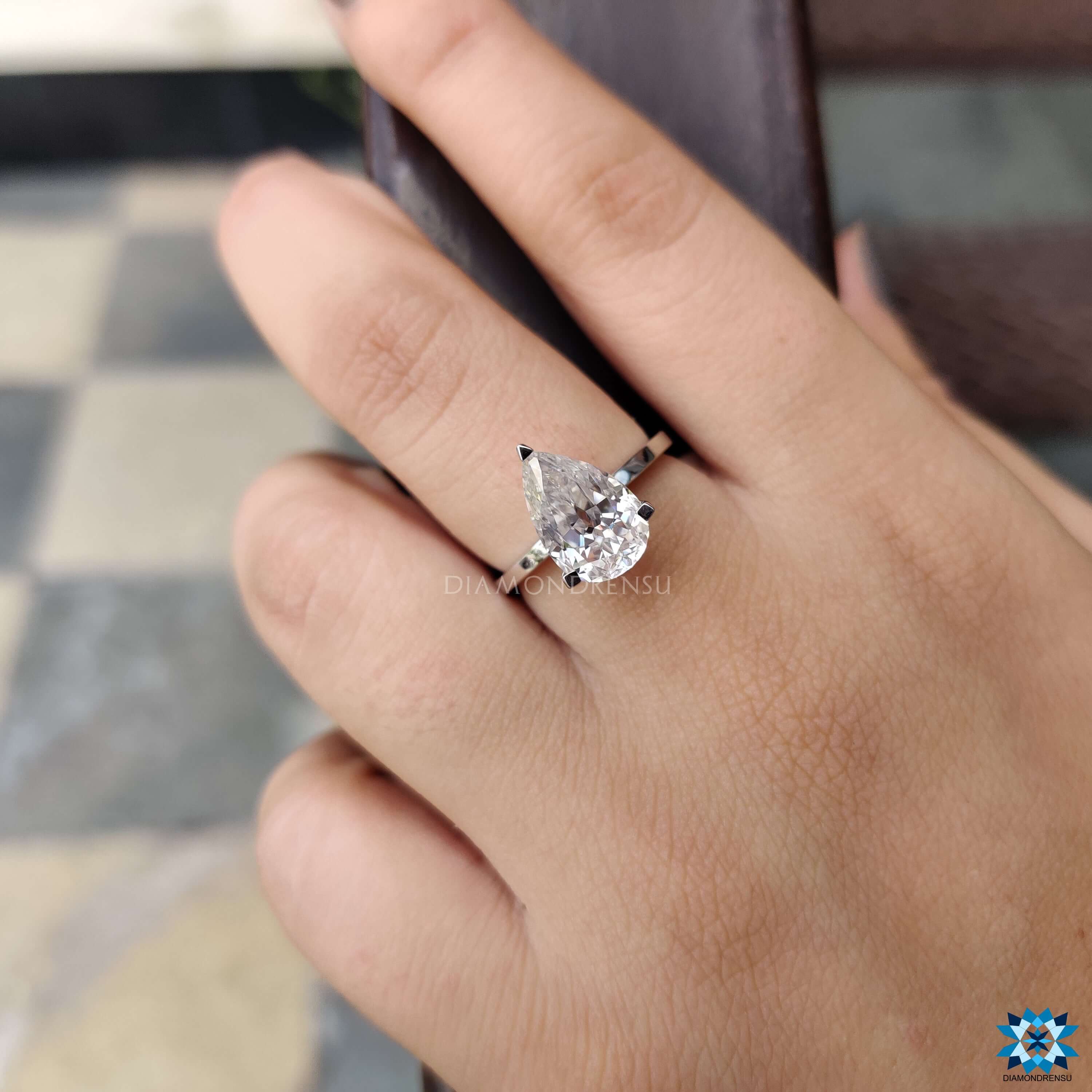 White gold solitaire ring with pear shaped moissanite.