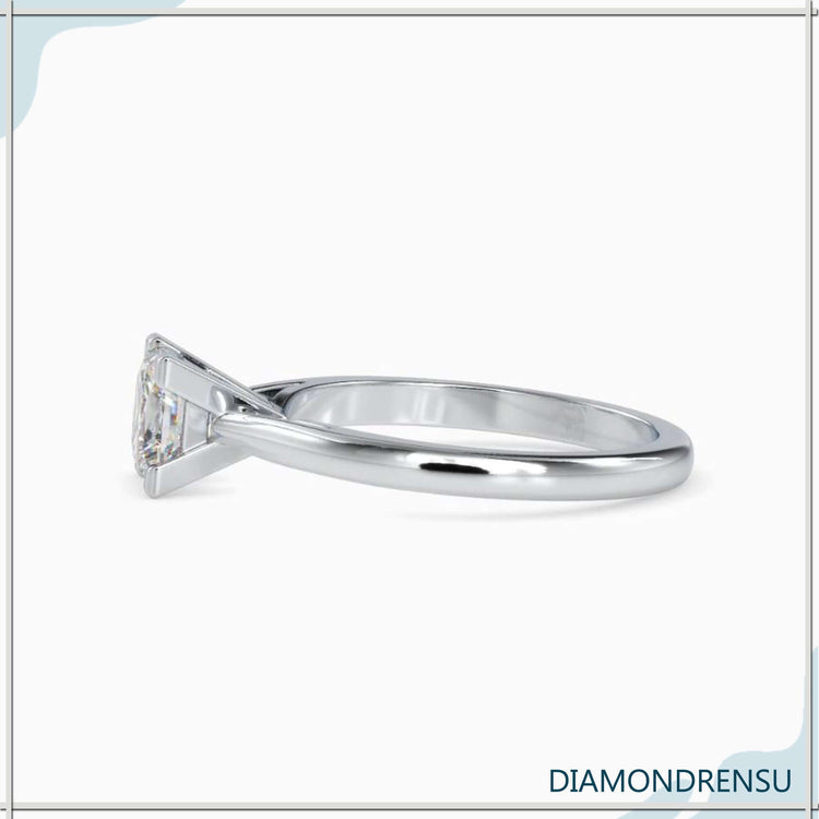 UK engagement ring with princess cut solitaire and white gold finish.