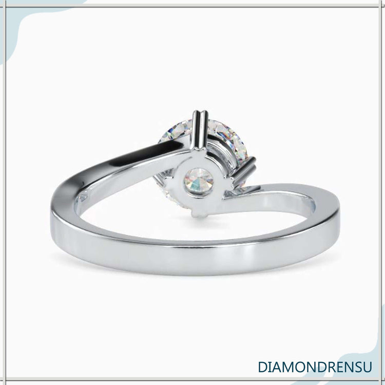 Custom engagement ring with heart prong and round cut stone.