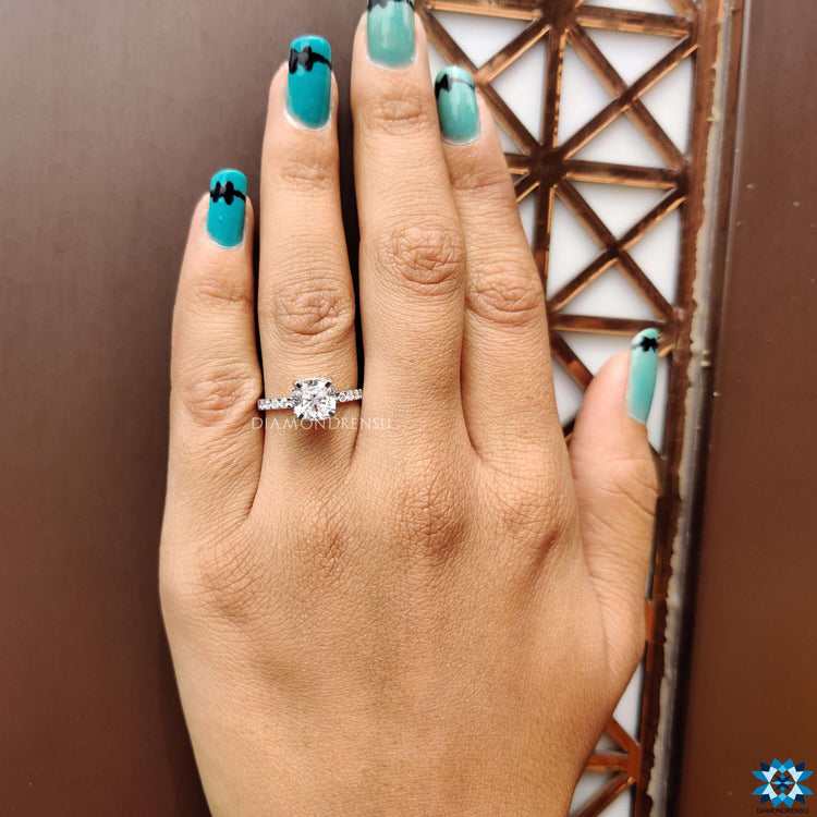Cushion cut moissanite ring with tab prong mount.