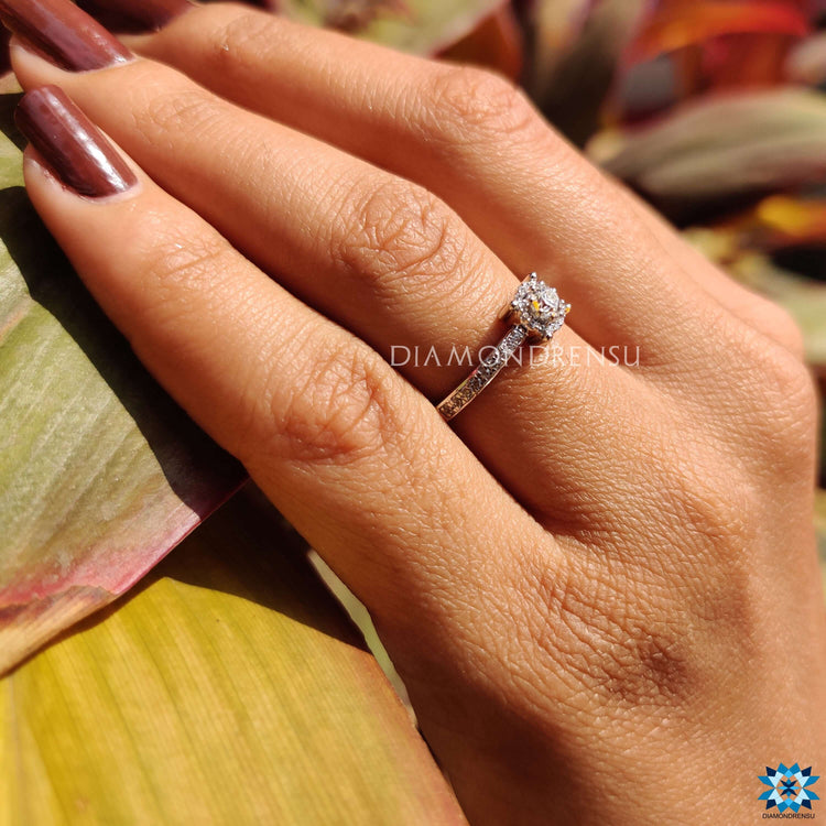 White gold ring with halo and prong set moissanite.