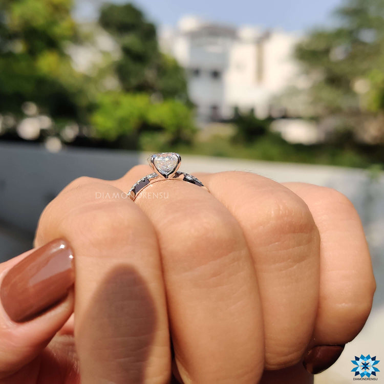 Prong set Portuguese cut moissanite ring crafted in white gold.