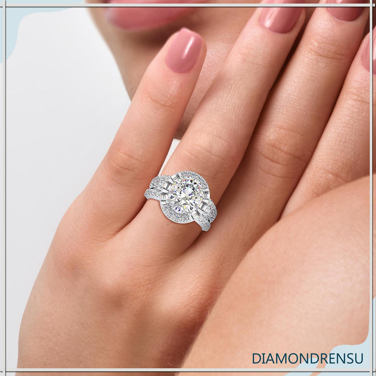 White gold ring featuring oval diamond and baguette halo.